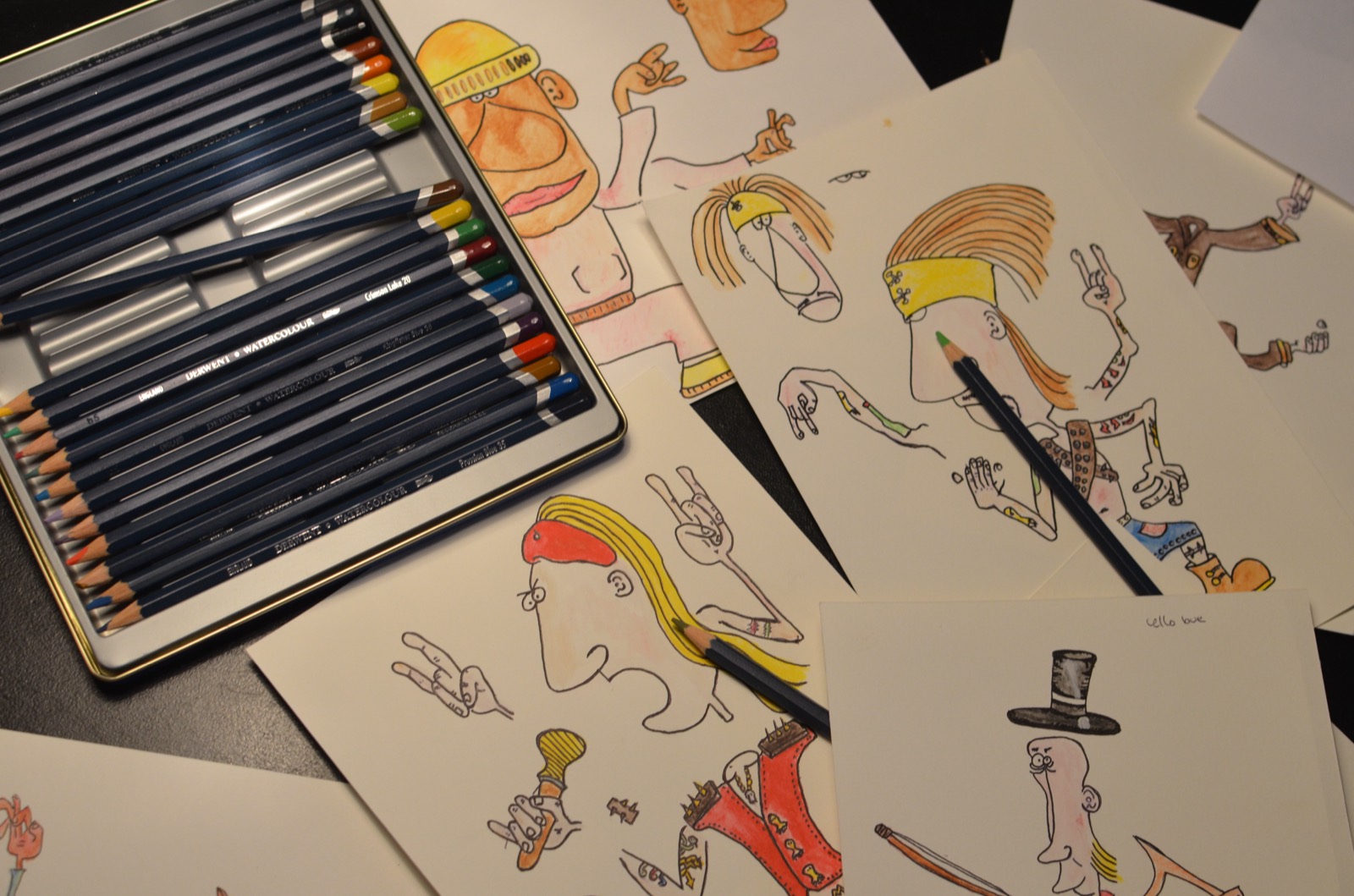 Colored pencils and original hand-drawn More Bands characters on paper